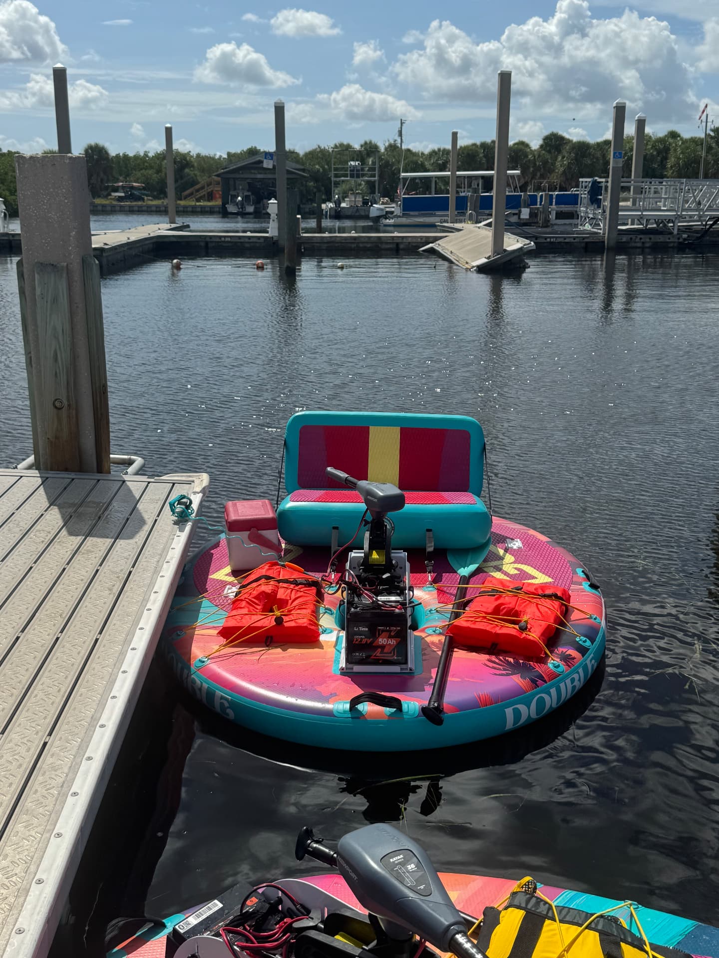 Coastal Cruisers GoBoats at the dock loaded with life jackets, paddles, and a cooler